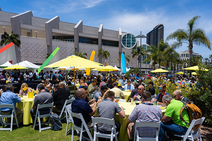 Hundreds of attendees eat lunch in the park outside the Convention Center.