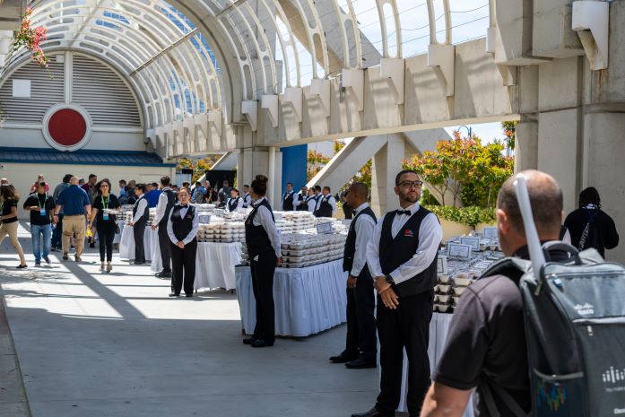 Food & beverage staff ready to serve attendees boxed lunches