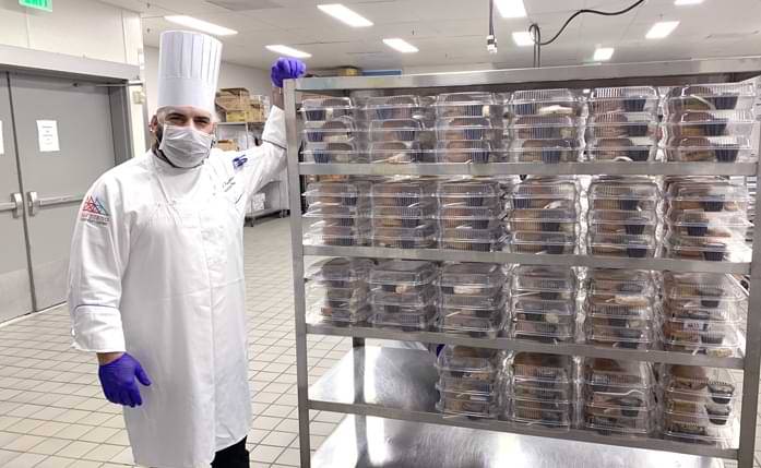 Chef Sufi in the East Kitchen with a giant cart of sandwiches