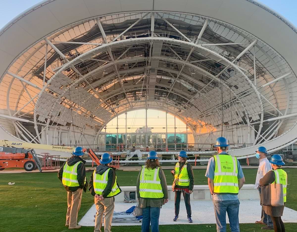 Group of staff in hard hats in front of The Shell’s stage 