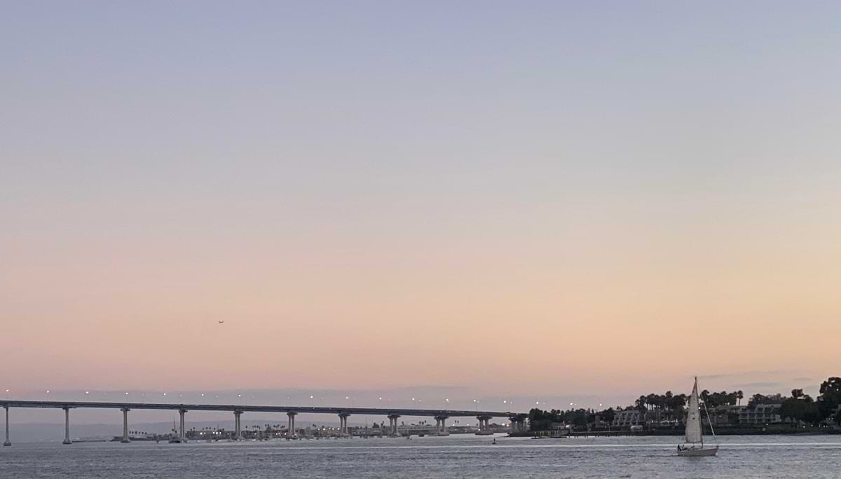 View of the Coronado Bridge and a sailboat on the San Diego Bay 