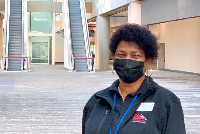 Jacquii Bogan-Bailey wearing a mask in front of SDCC escalators