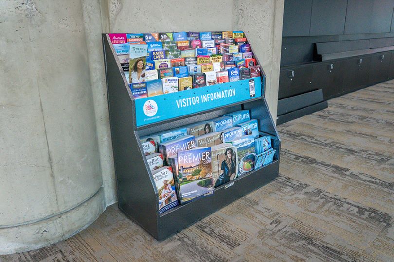 Brochure racks situated in the San Diego Convention Center lobby areas catch the attention of passing attendees.