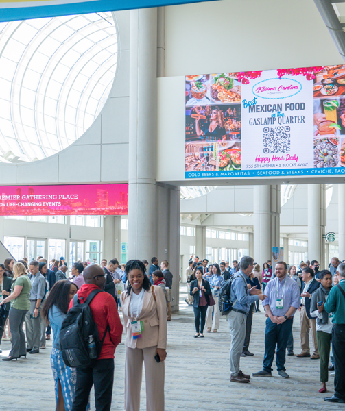 Attendees gather in the lobby spaces between meetings