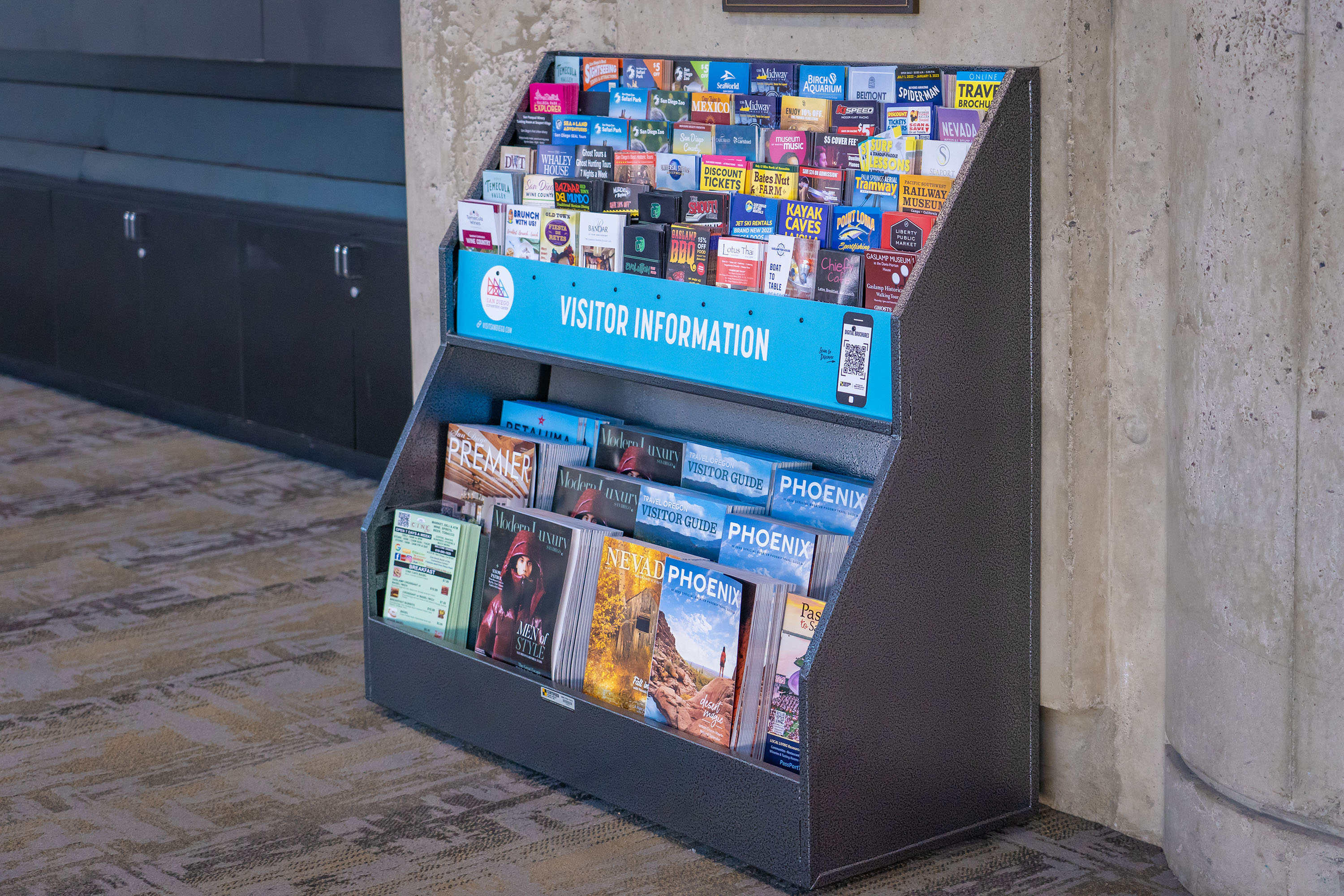 Brochure racks situated in the San Diego Convention Center lobby areas catch the attention of passing attendees.